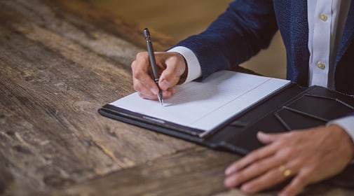 man writing notes